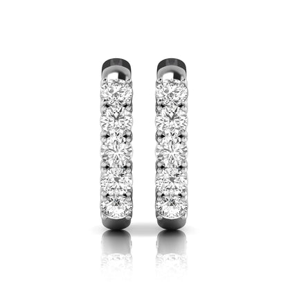Round cut lab grown diamond front-facing huggie hoop earrings featuring a shared four prong setting, hinged snap closure, and polished white gold finish.
