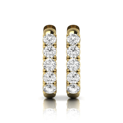 Round cut lab grown diamond front-facing huggie hoop earrings featuring a shared four prong setting, hinged snap closure, and polished yellow gold finish.