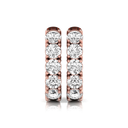 Round cut lab grown diamond huggie hoop earrings featuring five front-facing diamonds in a shared four prong setting with a hinged snap closure and polished rose gold finish.