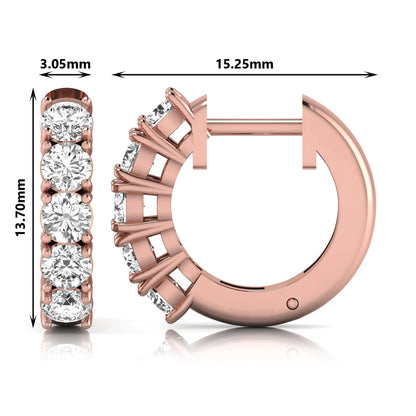 Round cut lab grown diamond huggie hoop earrings featuring five front-facing diamonds in a shared four prong setting with a hinged snap closure and polished rose gold finish.