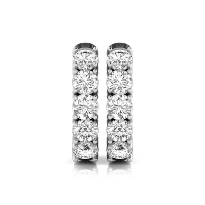 Round cut lab grown diamond huggie hoop earrings featuring five front-facing diamonds in a shared four prong setting with a hinged snap closure and polished white gold finish.
