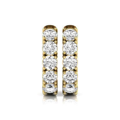 Round cut lab grown diamond huggie hoop earrings featuring five front-facing diamonds in a shared four prong setting with a hinged snap closure and polished yellow gold finish.