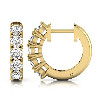 Round cut lab grown diamond huggie hoop earrings featuring five front-facing diamonds in a shared four prong setting with a hinged snap closure and polished yellow gold finish.