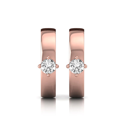 Round cut lab grown diamond huggie hoop earrings featuring a four prong setting and hinged snap closure shown in rose gold tone with a polished finish.