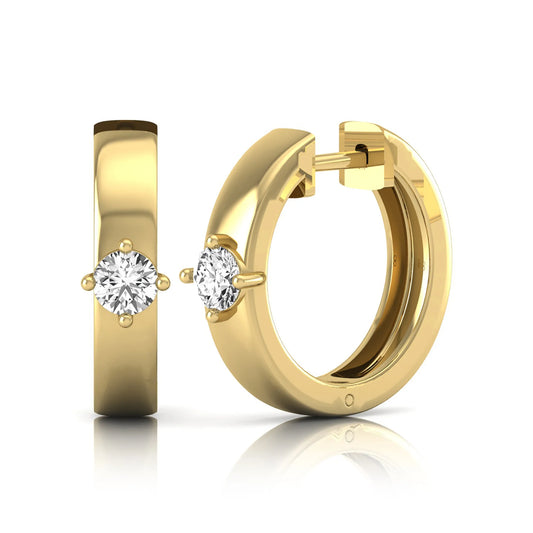 Round cut lab grown diamond huggie hoop earrings featuring a four prong setting and hinged snap closure shown in yellow gold tone with a polished finish.