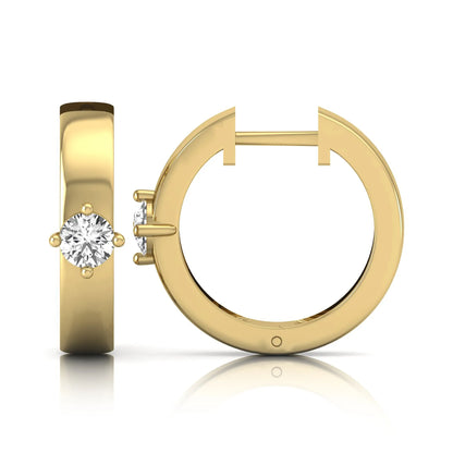 Round cut lab grown diamond huggie hoop earrings featuring a four prong setting and hinged snap closure shown in yellow gold tone with a polished finish.