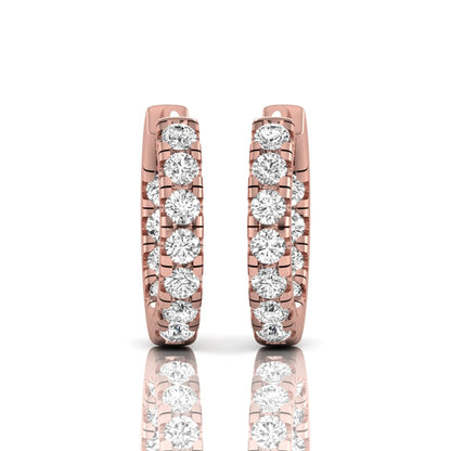 Round prong set lab grown diamond huggie hoop earrings featuring round cut diamonds in a classic hinged hoop design with rose gold tone shown for display.