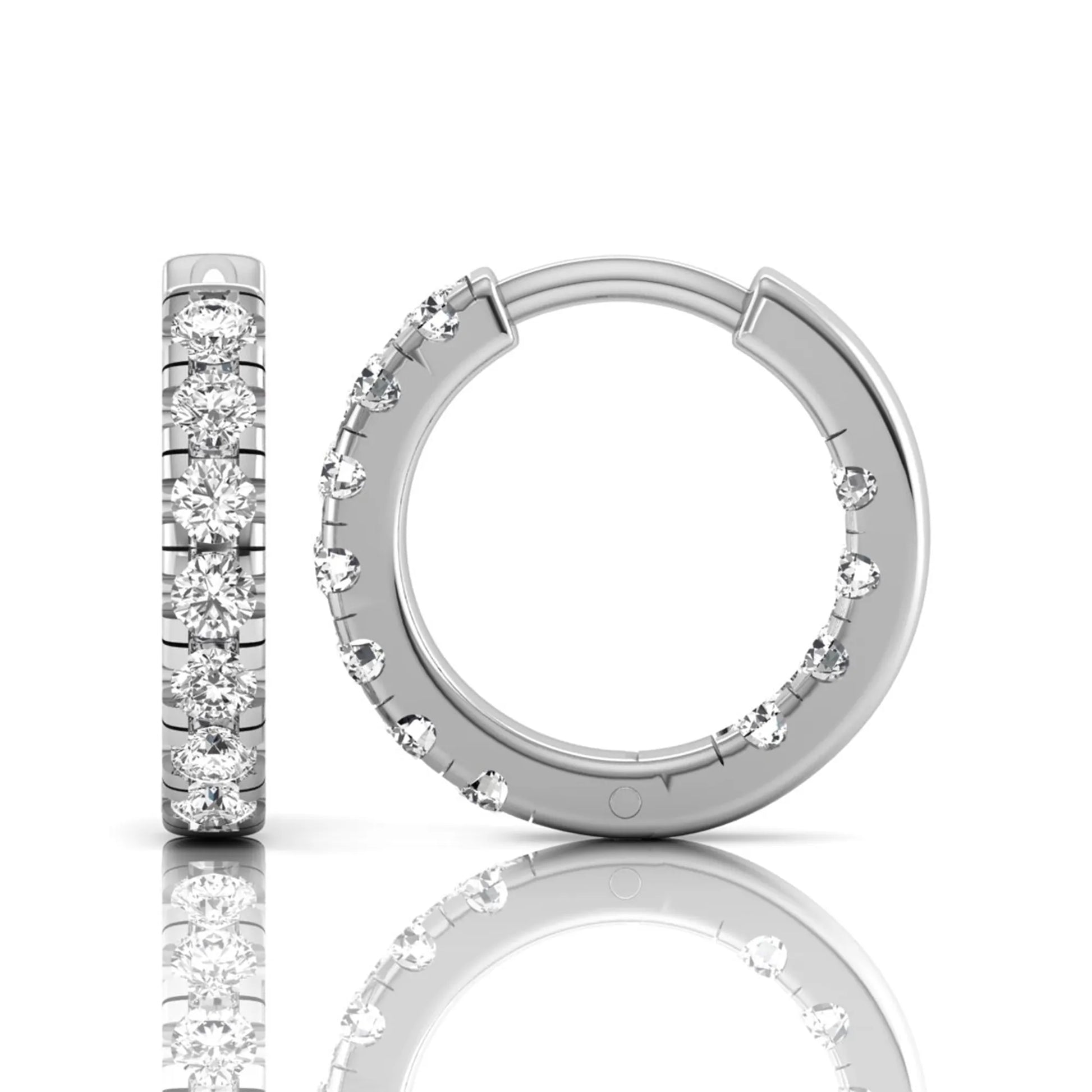 Round prong set lab grown diamond huggie hoop earrings featuring round cut diamonds in a classic hinged hoop design with white gold tone shown for display.