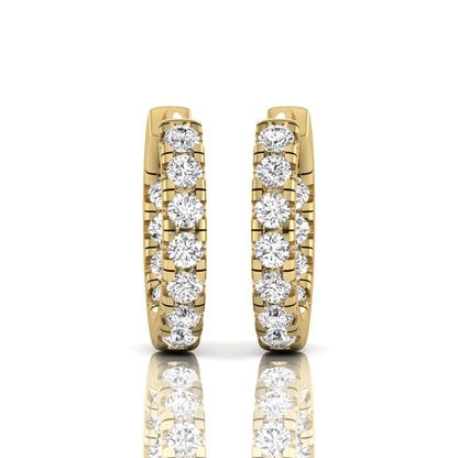Round prong set lab grown diamond huggie hoop earrings featuring round cut diamonds in a classic hinged hoop design with yellow gold tone shown for display.