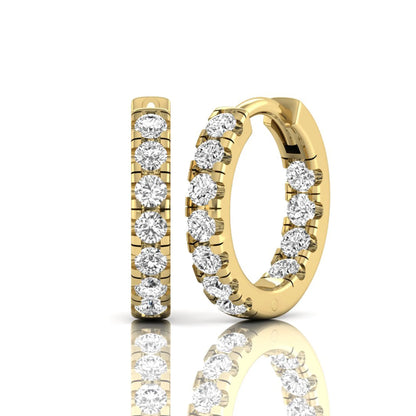 Round prong set lab grown diamond huggie hoop earrings featuring round cut diamonds in a classic hinged hoop design with yellow gold tone shown for display.