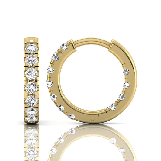 Round prong set lab grown diamond huggie hoop earrings featuring round cut diamonds in a classic hinged hoop design with yellow gold tone shown for display.