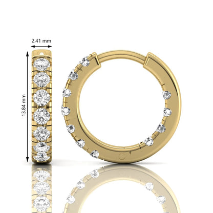 Round prong set lab grown diamond huggie hoop earrings featuring round cut diamonds in a classic hinged hoop design with yellow gold tone shown for display.