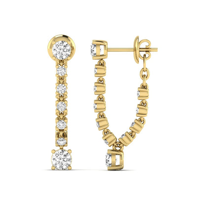 Round prong set lab grown diamond linear drop earrings featuring graduated round diamonds in a yellow gold finish with push back closure.