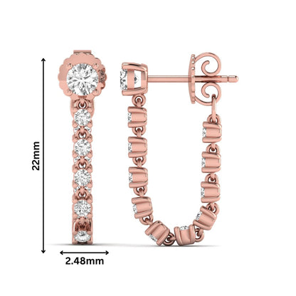 Round prong set lab grown diamond linear drop earrings featuring graduated round cut diamonds in a rose gold finish with push back closure.