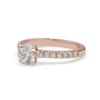 rose gold Round cut lab grown diamond prong set engagement ring with pavé band and yellow metal tone design