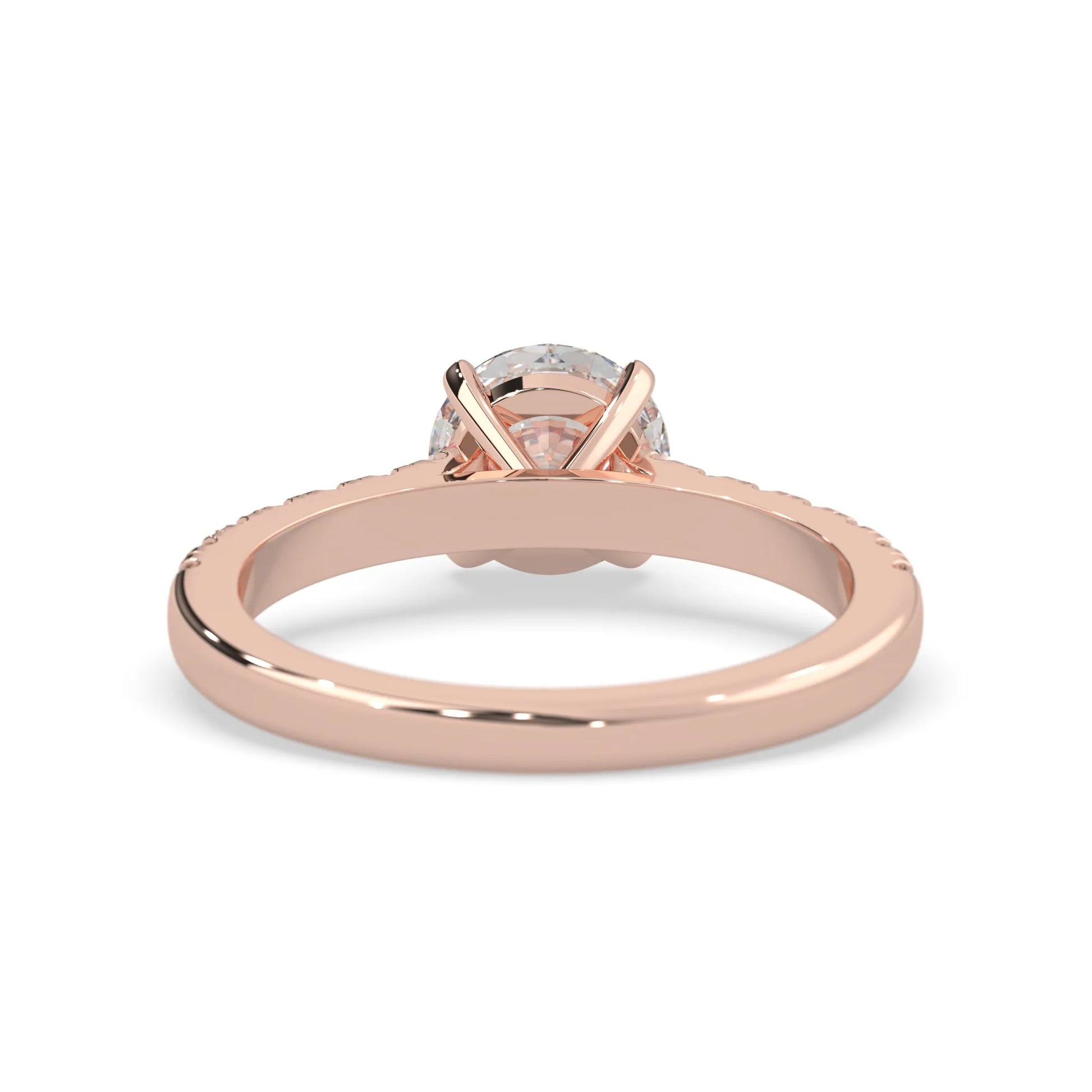 rose gold Round cut lab grown diamond prong set engagement ring with pavé band and yellow metal tone design