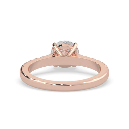 rose gold Round cut lab grown diamond prong set engagement ring with pavé band and yellow metal tone design