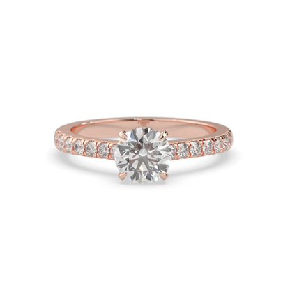 rose gold Round cut lab grown diamond prong set engagement ring with pavé band and yellow metal tone design