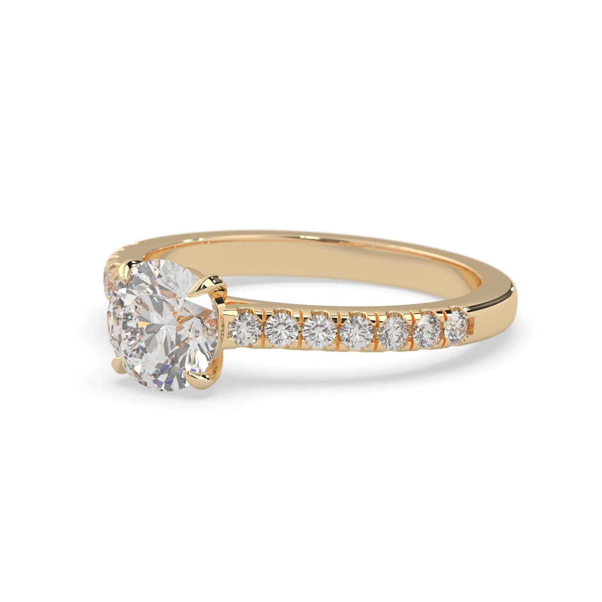 yellow gold Round cut lab grown diamond prong set engagement ring with pavé band and yellow metal tone design