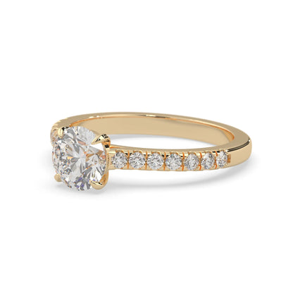 yellow gold Round cut lab grown diamond prong set engagement ring with pavé band and yellow metal tone design