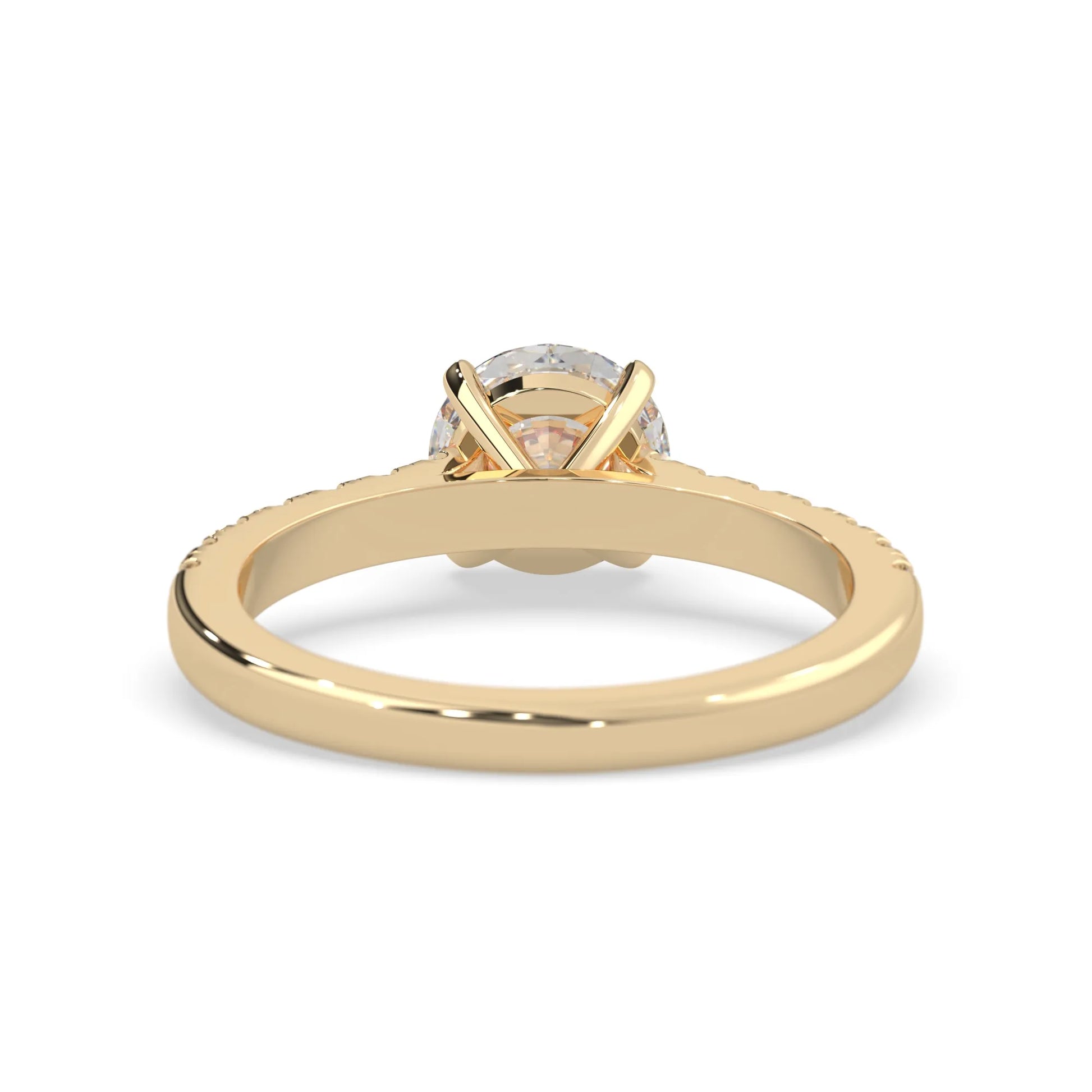 yellow gold Round cut lab grown diamond prong set engagement ring with pavé band and yellow metal tone design