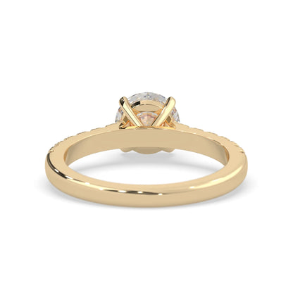 yellow gold Round cut lab grown diamond prong set engagement ring with pavé band and yellow metal tone design