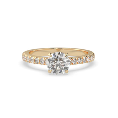 yellow gold Round cut lab grown diamond prong set engagement ring with pavé band and yellow metal tone design