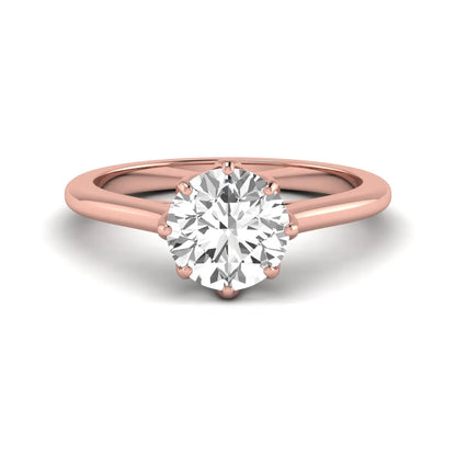 Round cut lab grown diamond solitaire engagement ring featuring a six-prong setting and polished rose gold tone band.