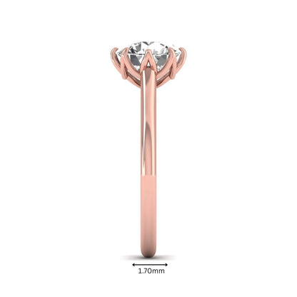 Round cut lab grown diamond solitaire engagement ring featuring a six-prong setting and polished rose gold tone band.