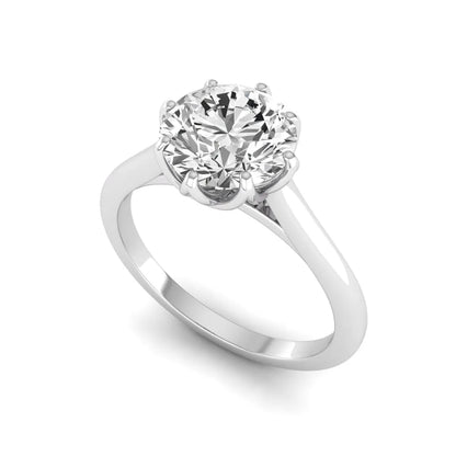Round cut lab grown diamond solitaire engagement ring featuring a six-prong setting and polished white gold tone band.