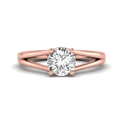 Round cut lab grown diamond solitaire split shank engagement ring with classic prong setting and rose gold tone shown for design reference.