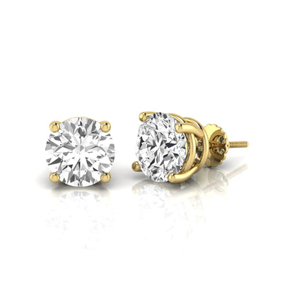 Round cut lab grown diamond stud earrings featuring a classic four-prong setting with secure screw back closure in a yellow gold tone.