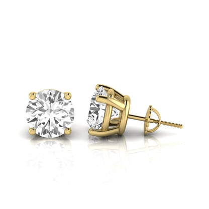 Round cut lab grown diamond stud earrings featuring a classic four-prong setting with secure screw back closure in a yellow gold tone.