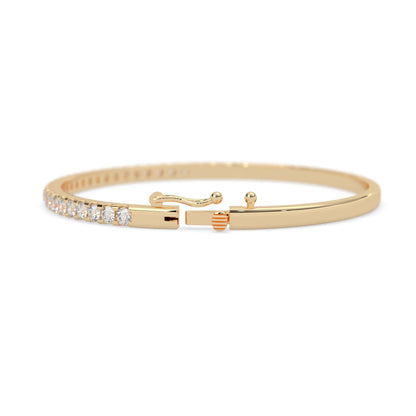yellow gold Round cut prong set lab grown diamond tennis bangle bracelet featuring a sleek polished design.