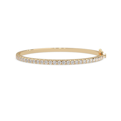 yellow gold Round cut prong set lab grown diamond tennis bangle bracelet featuring a sleek polished design.