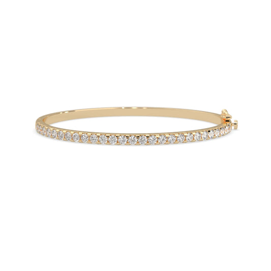 yellow gold Round cut prong set lab grown diamond tennis bangle bracelet featuring a sleek polished design.