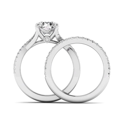Round prong set lab grown diamond twisted shank bridal ring set featuring a 2.00 carat round center diamond with pavé round side diamonds in white gold finish.