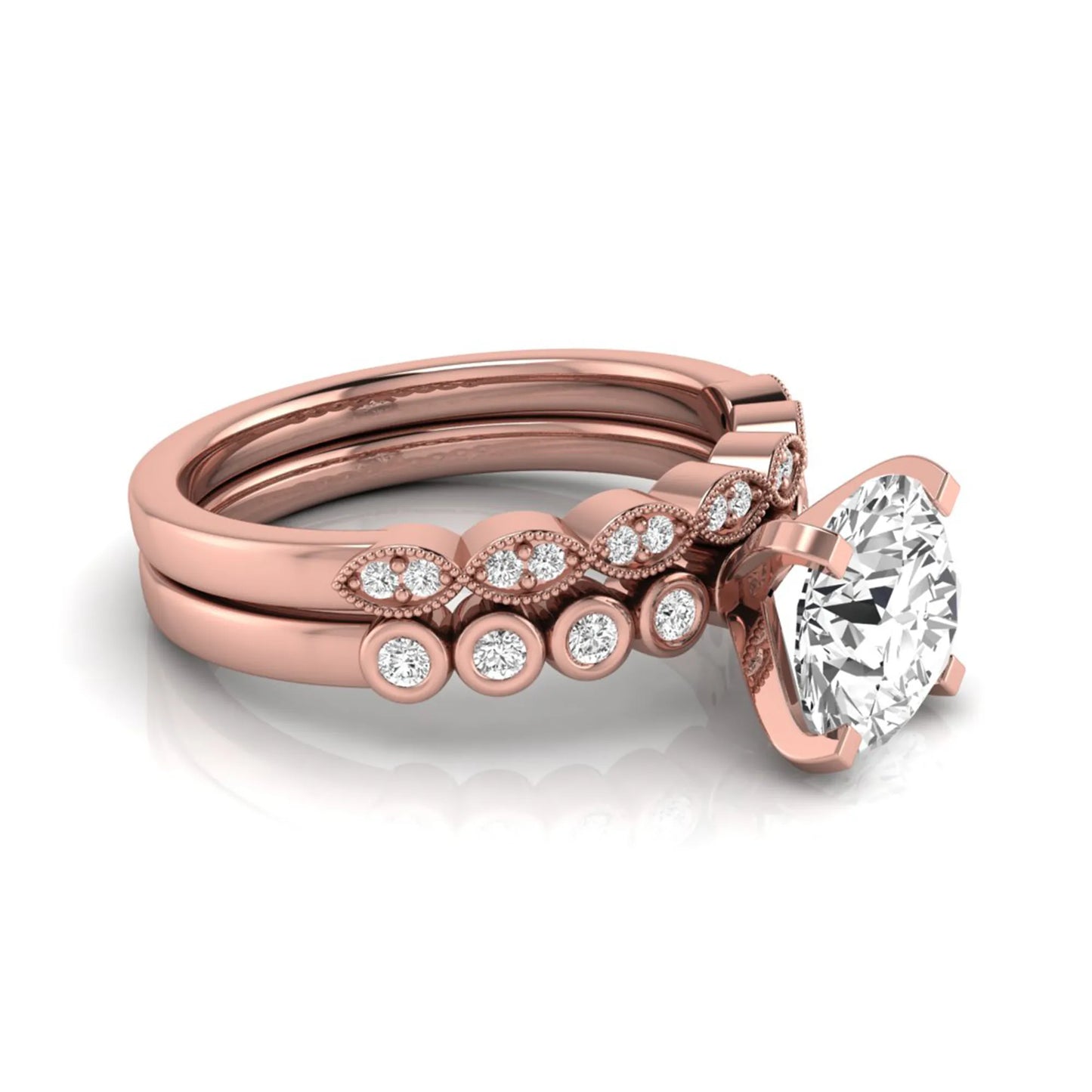 Round cut lab grown diamond bridal ring set featuring a four-prong solitaire engagement ring with a matching side stone wedding band accented by round bezel-set diamonds and vintage milgrain detailing.