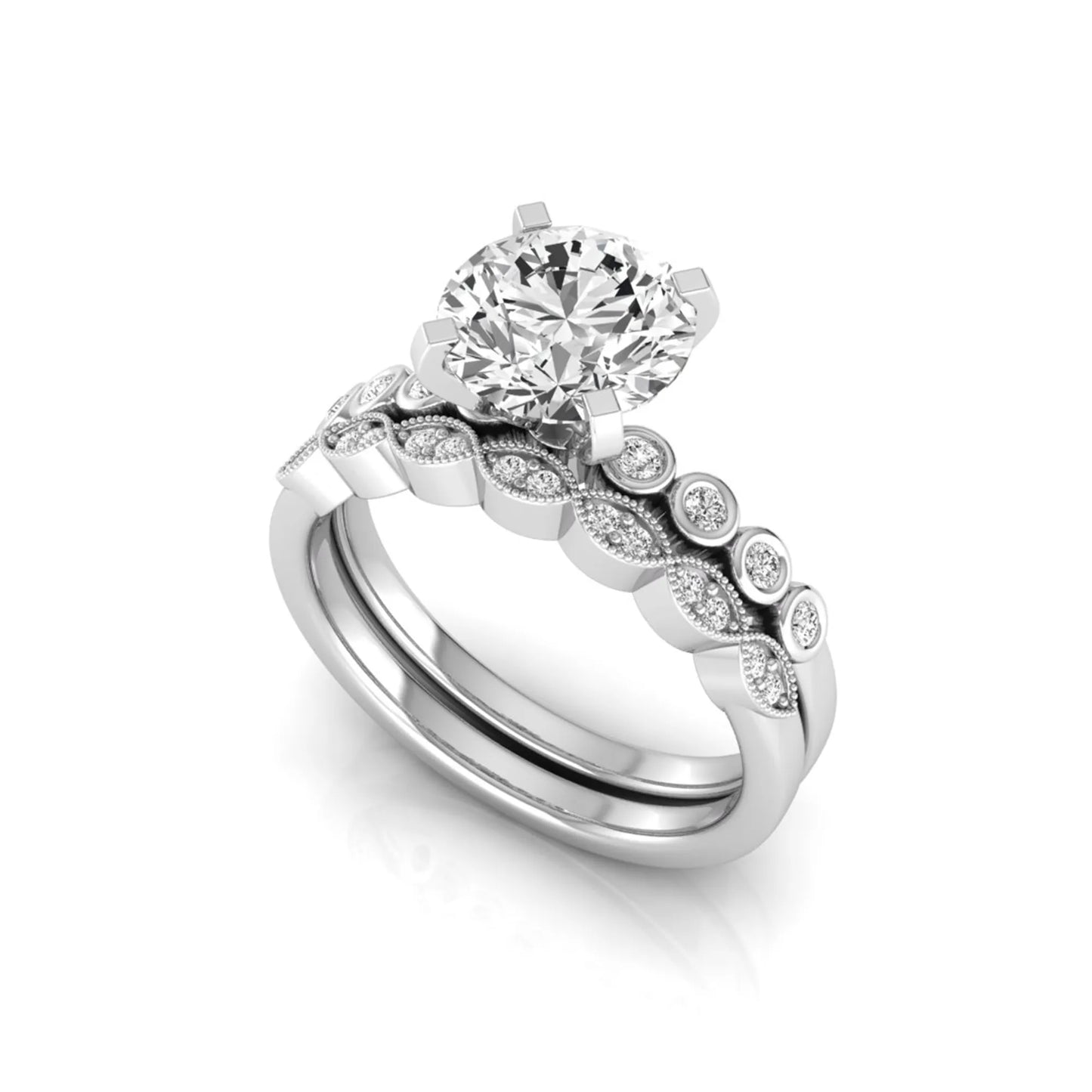 Round cut lab grown diamond bridal ring set featuring a four-prong solitaire engagement ring with a matching side stone wedding band accented by round bezel-set diamonds and vintage milgrain detailing in white gold
