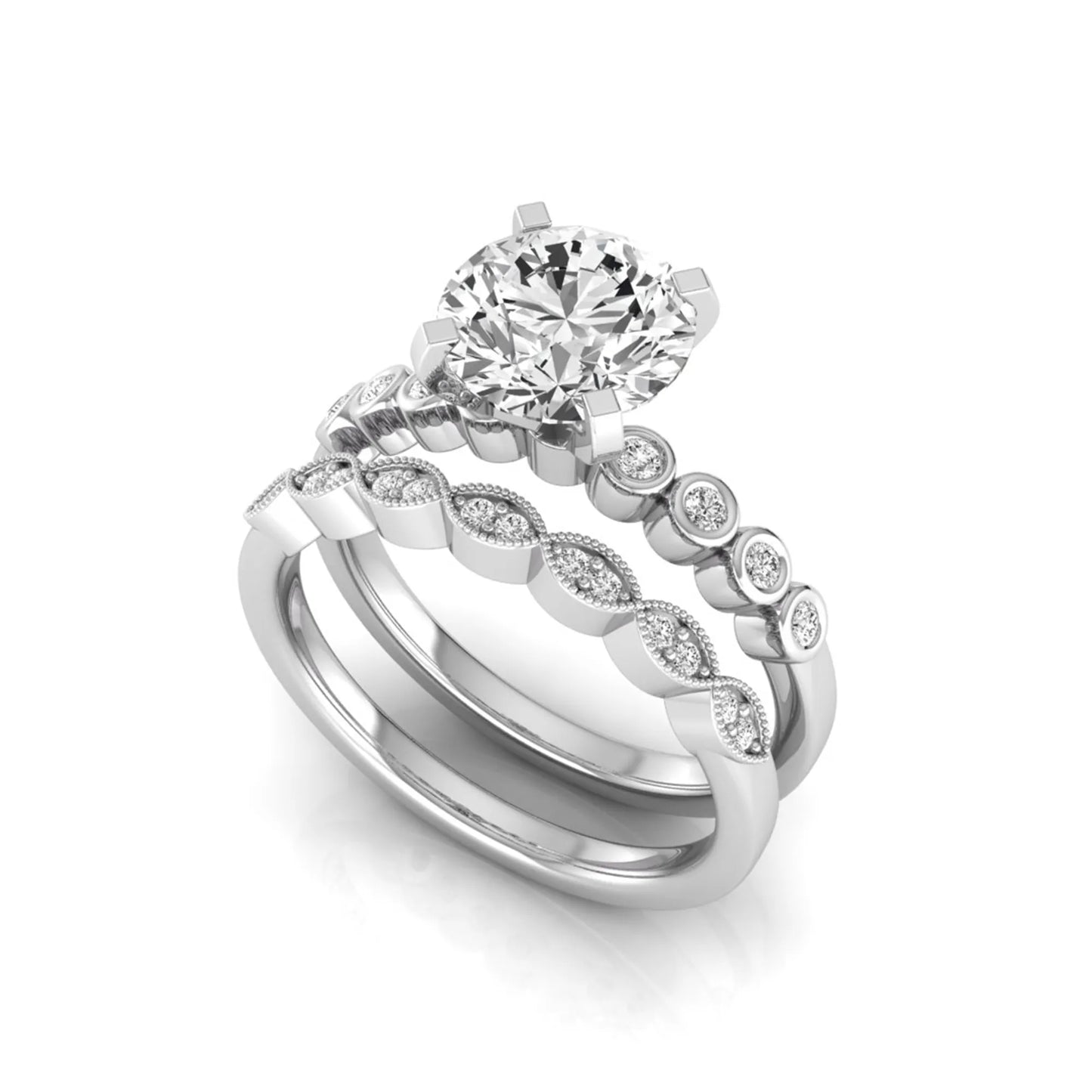 Round cut lab grown diamond bridal ring set featuring a four-prong solitaire engagement ring with a matching side stone wedding band accented by round bezel-set diamonds and vintage milgrain detailing in white gold