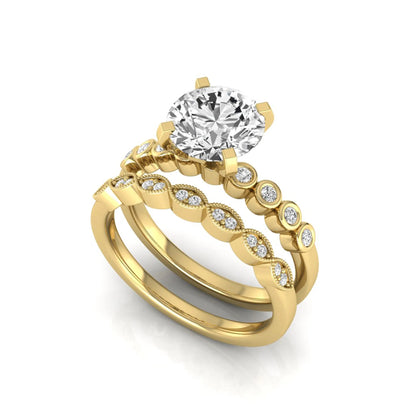 Round cut lab grown diamond bridal ring set featuring a four-prong solitaire engagement ring with a matching side stone wedding band accented by round bezel-set diamonds and vintage milgrain detailing in yellow gold