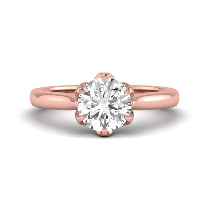 Round cut lab grown diamond solitaire engagement ring featuring a classic six-prong setting in rose gold tone design.