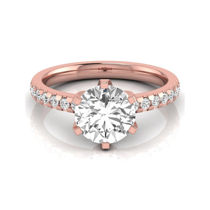 Round cut lab grown diamond solitaire engagement ring featuring a six-prong setting with a pavé diamond band in rose gold tone.