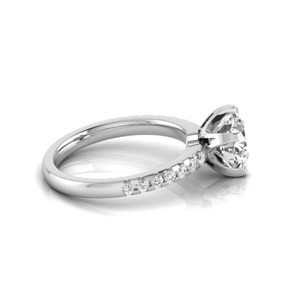 Round cut lab grown diamond solitaire engagement ring featuring a six-prong setting with a pavé diamond band in white gold tone.