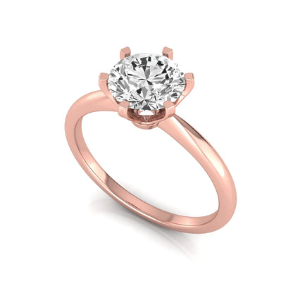 Round six prong set lab grown diamond solitaire engagement ring featuring a 1.28 carat round center diamond in a classic six-prong setting in rose gold
