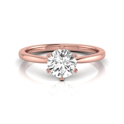 Round six prong set lab grown diamond solitaire engagement ring featuring a 1.28 carat round center diamond in a classic six-prong setting in rose gold