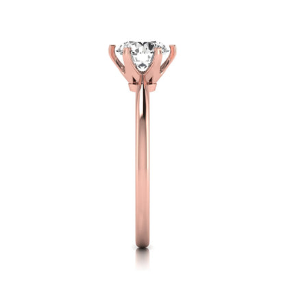 Round six prong set lab grown diamond solitaire engagement ring featuring a 1.28 carat round center diamond in a classic six-prong setting in rose gold