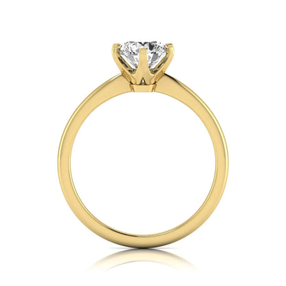 Round six prong set lab grown diamond solitaire engagement ring featuring a 1.28 carat round center diamond in a classic six-prong setting in yellow gold