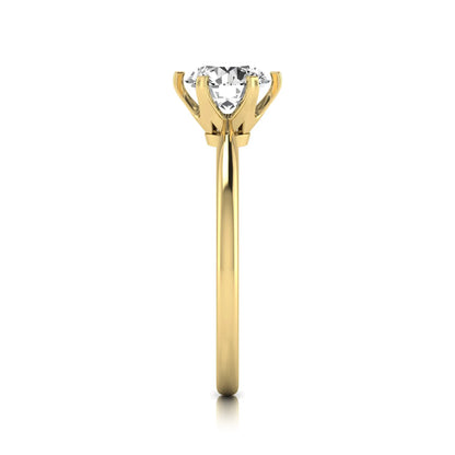 Round six prong set lab grown diamond solitaire engagement ring featuring a 1.28 carat round center diamond in a classic six-prong setting in yellow gold