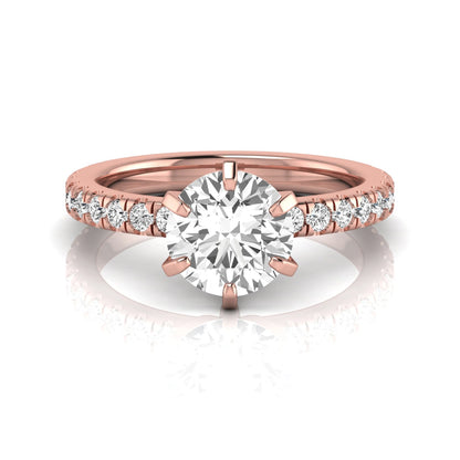 Round cut lab grown diamond engagement ring featuring a six-prong solitaire setting with a pavé accent band and polished rose gold tone finish.